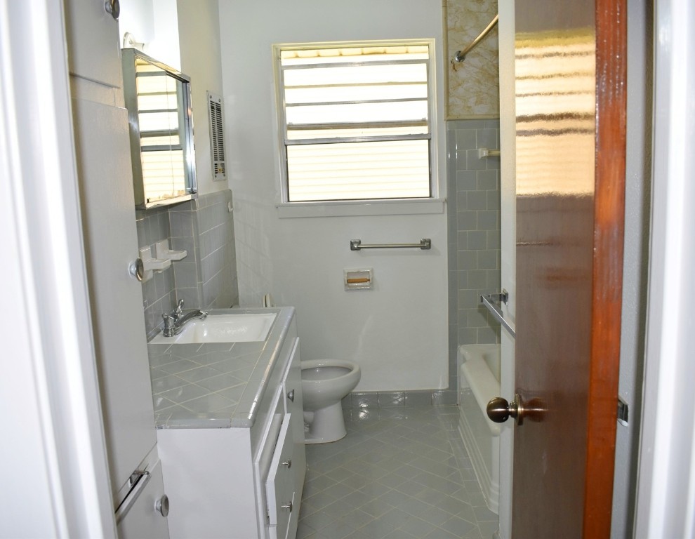 5126 Beechnut Street Houston, TX 77096 - Photo 15 of 20 a bathroom with a granite countertop sink toilet and shower