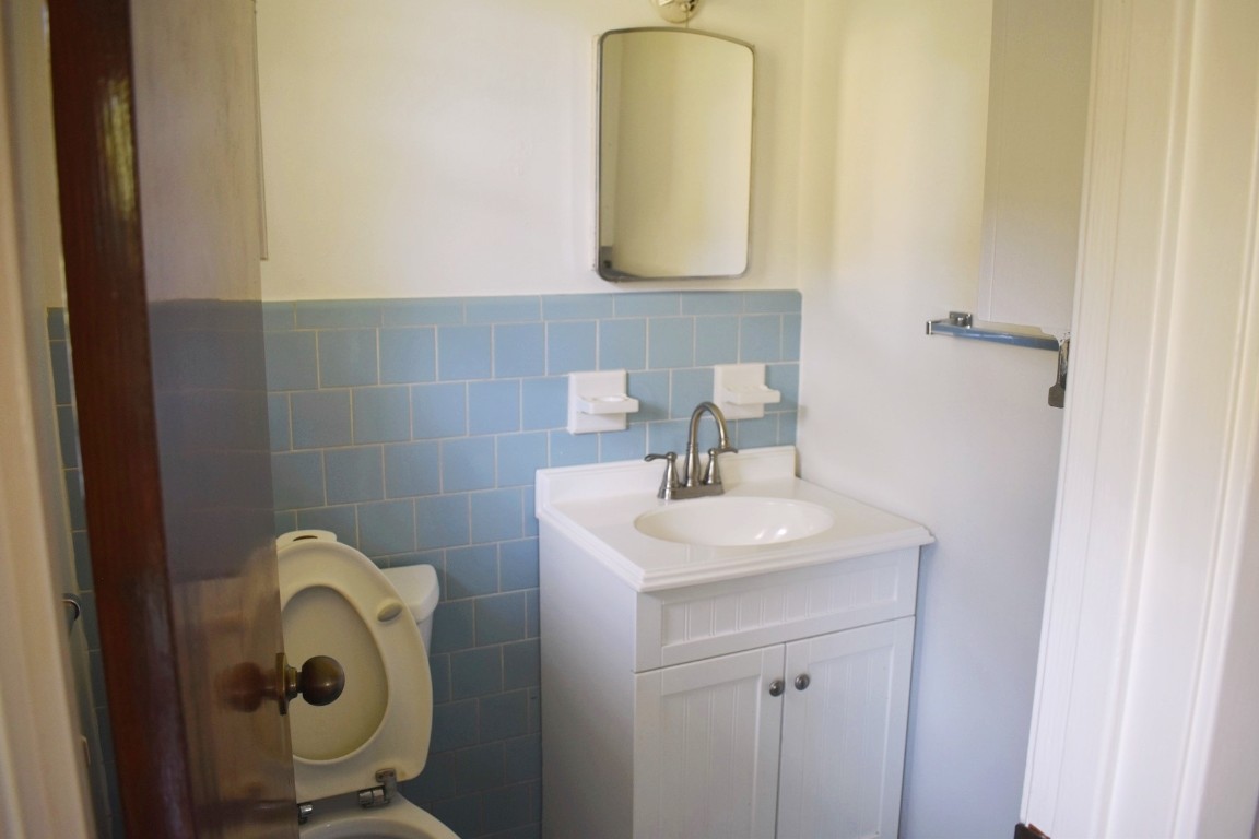 5126 Beechnut Street Houston, TX 77096 - Photo 17 of 20 a bathroom with a sink and a mirror
