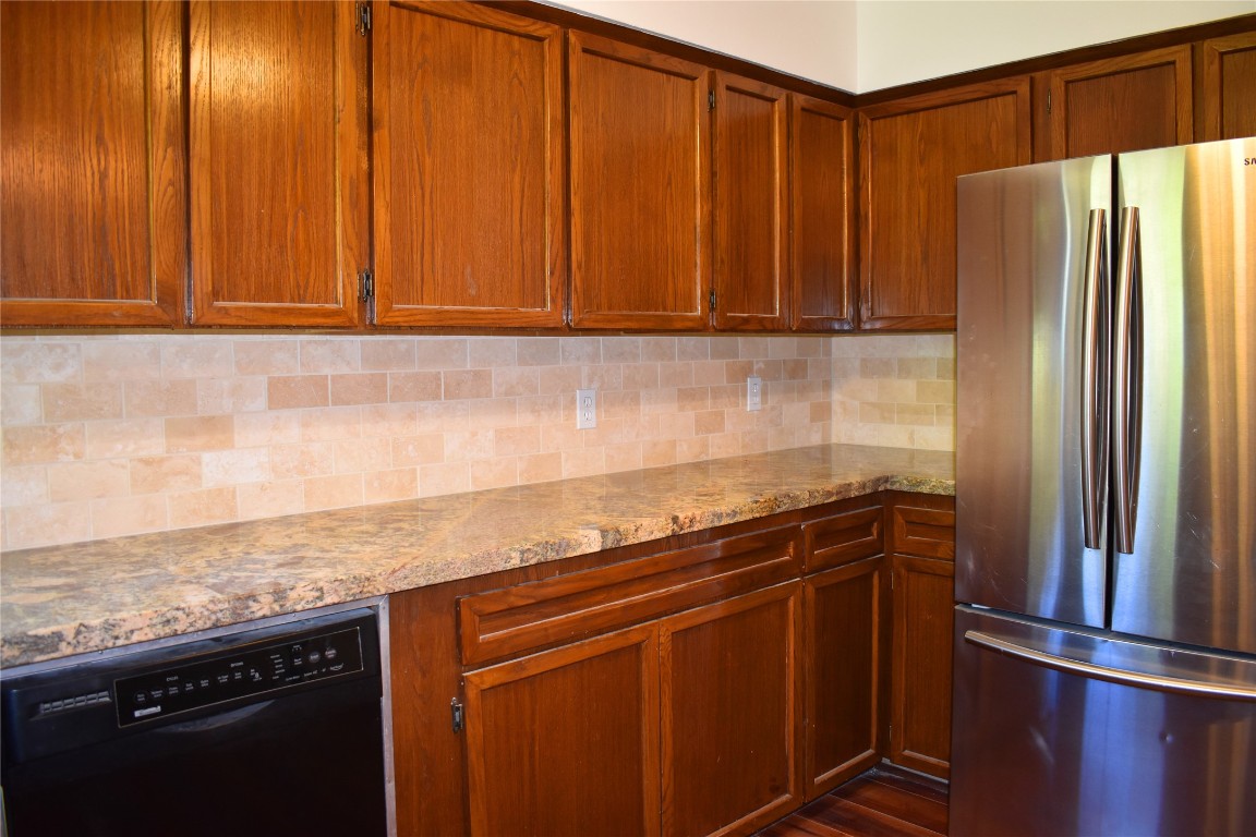 5126 Beechnut Street Houston, TX 77096 - Photo 8 of 20 a kitchen with stainless steel appliances granite countertop a refrigerator and a sink