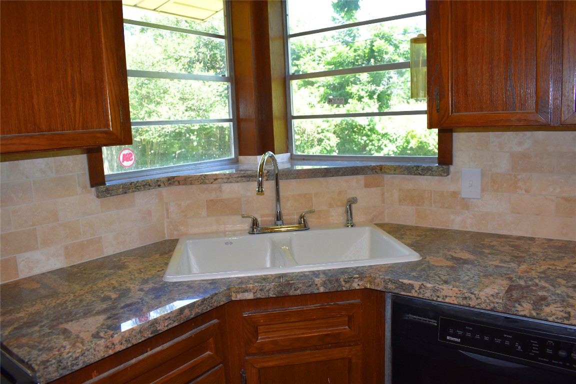 5126 Beechnut Street Houston, TX 77096 - Photo 9 of 20 a kitchen with granite countertop a sink and a window