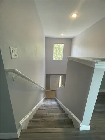 a view of entryway and hall with wooden floor