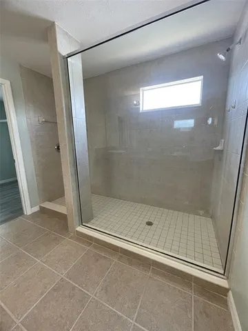 a bathroom with a glass shower door