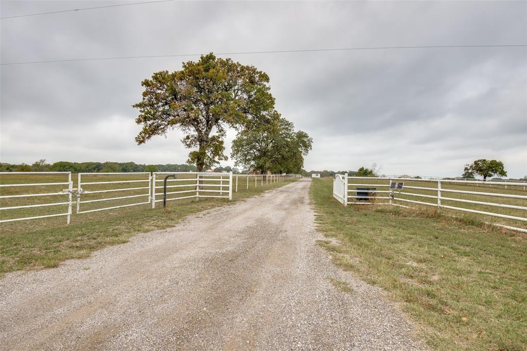 a view of a yard with wooden fence