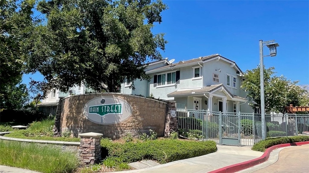 8074 Joplin Place, Unit 103 Rancho Cucamonga, CA 91730 - Photo 1 of 1 a front view of a house with a garden