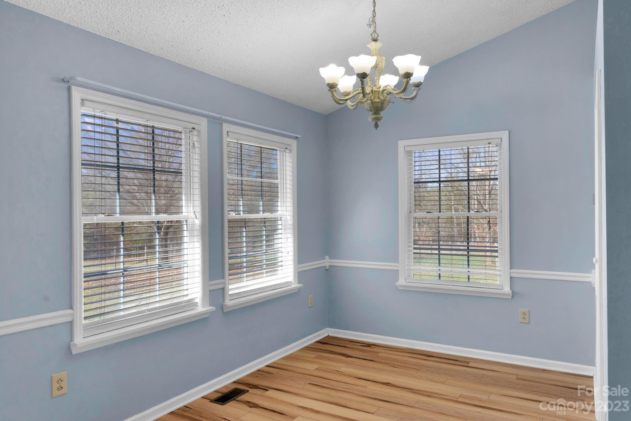 7861 Fisher Road Mount Pleasant, NC 28124 - Photo 12 of 48 a view of wooden room with windows and chandelier