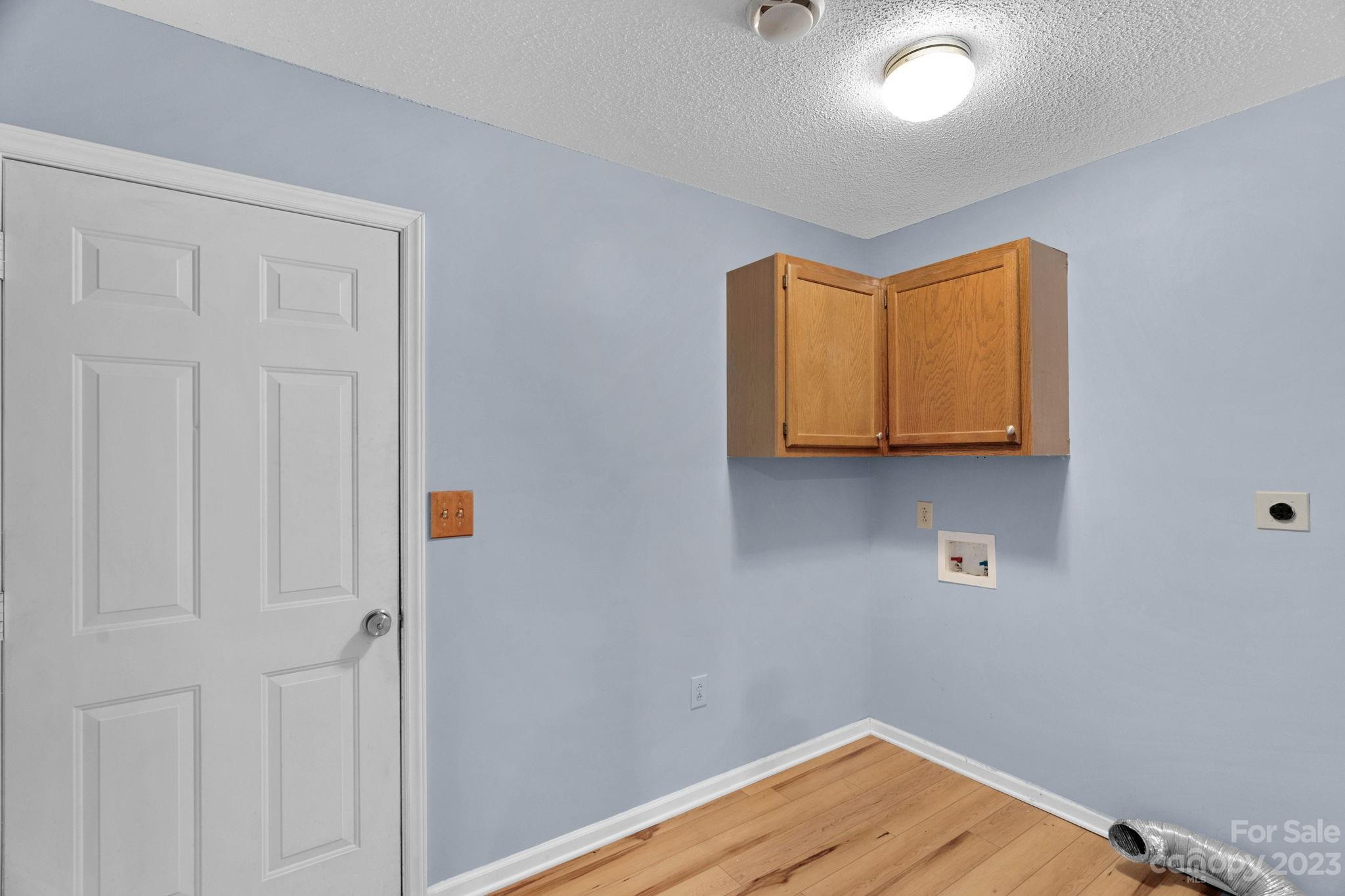 7861 Fisher Road Mount Pleasant, NC 28124 - Photo 21 of 48 a room with a wooden floor and white cabinet