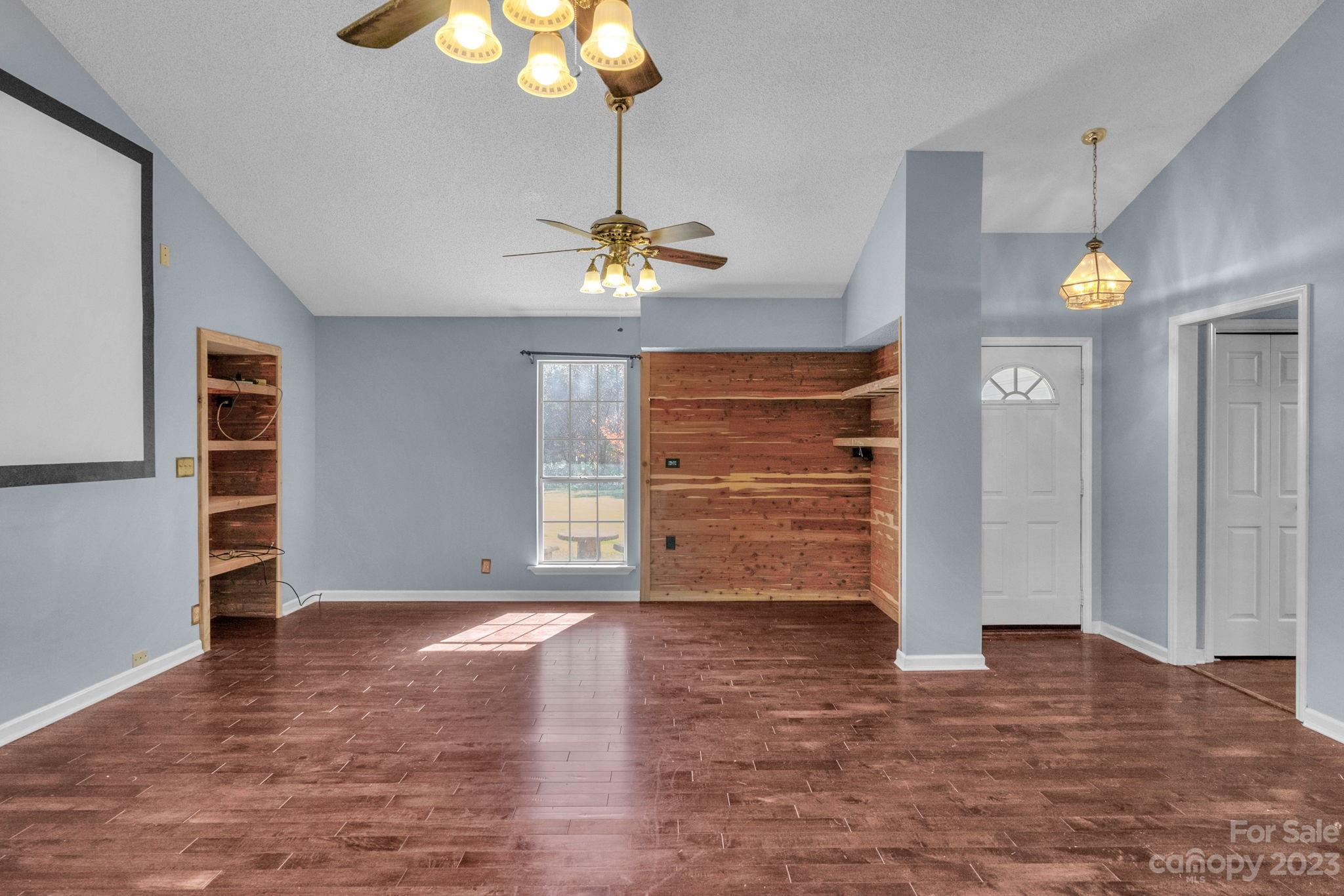 7861 Fisher Road Mount Pleasant, NC 28124 - Photo 8 of 48 a view of an empty room with a window and wooden floor