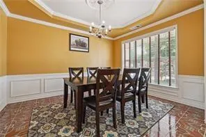 a view of a dining room with furniture and window