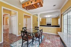 a view of a dining room with furniture and a chandelier