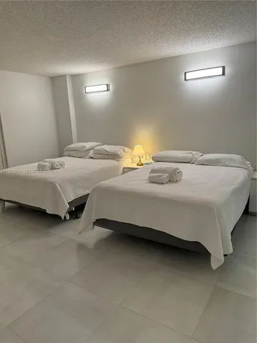 a bedroom with bed and window