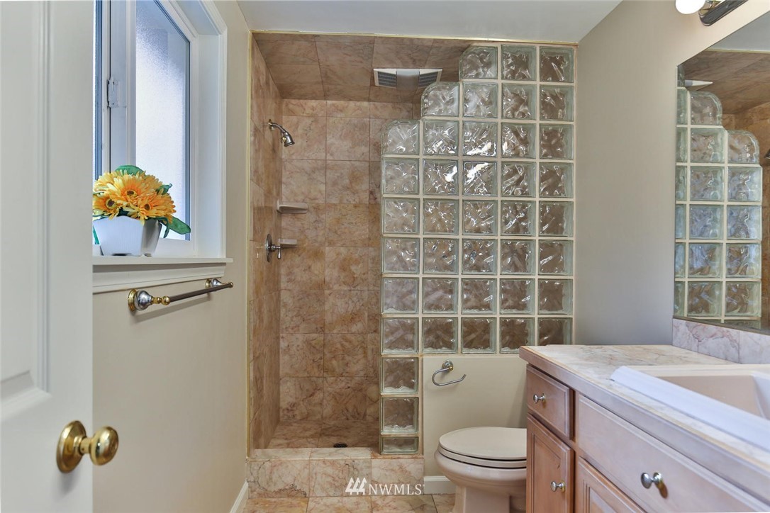 404 170th Place Southwest Bothell, WA 98012 - Photo 14 of 25 a bathroom with a granite countertop sink a toilet and shower