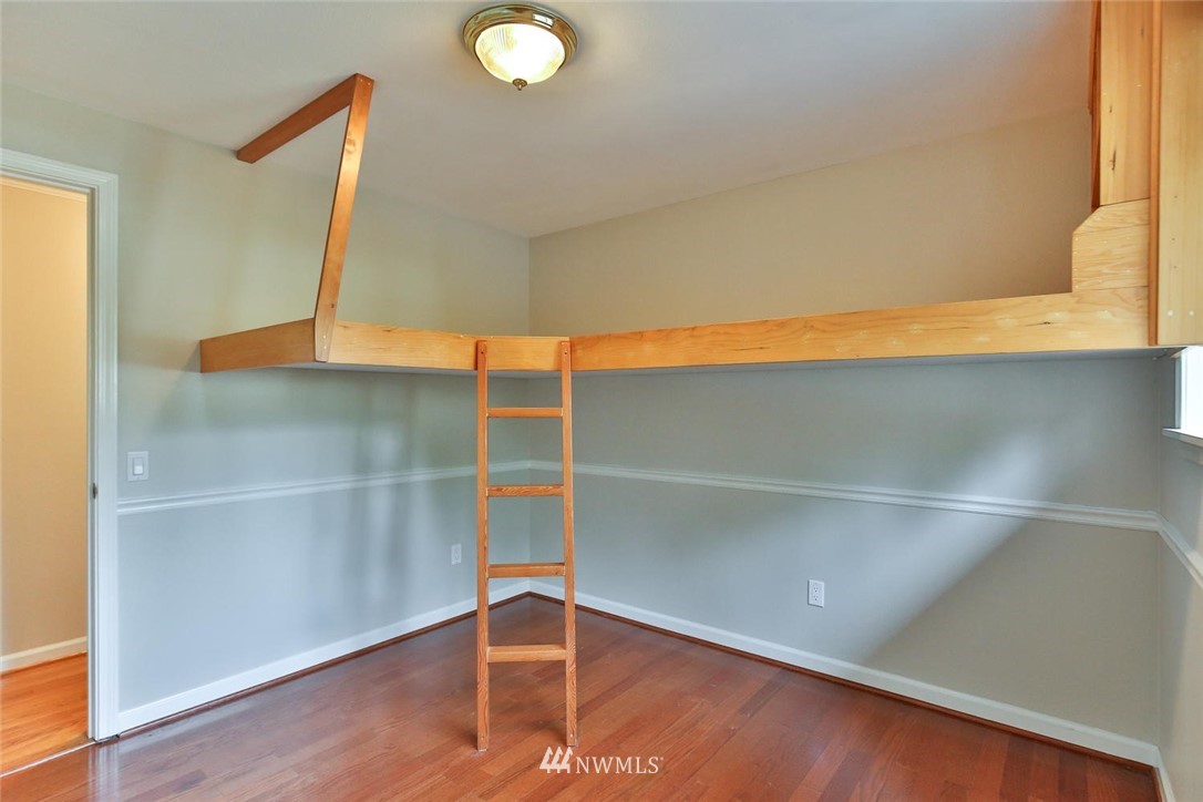 404 170th Place Southwest Bothell, WA 98012 - Photo 16 of 25 a view of an empty room with wooden floor and a window