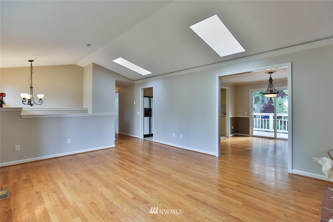 404 170th Place Southwest Bothell, WA 98012 - Photo 6 of 25 a view of an empty room with wooden floor and a window