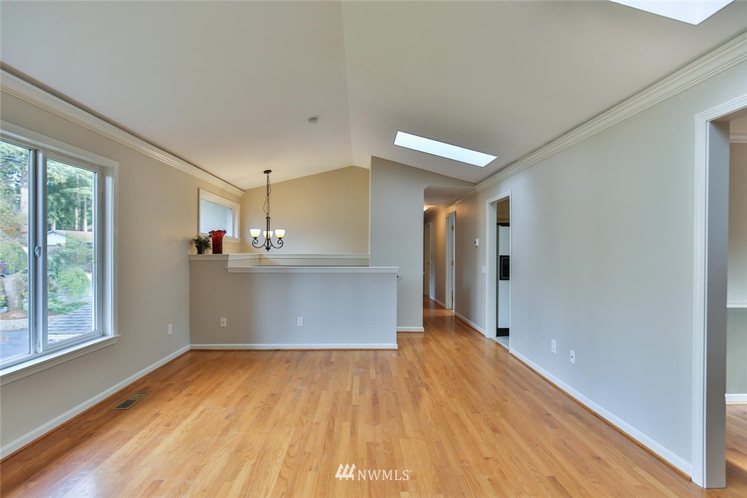 404 170th Place Southwest Bothell, WA 98012 - Photo 7 of 25 a view of a kitchen with a fridge and wooden floor