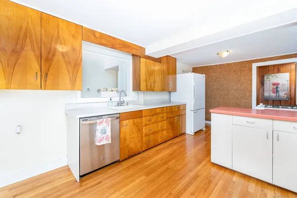 a kitchen with stainless steel appliances granite countertop a sink and wooden cabinets