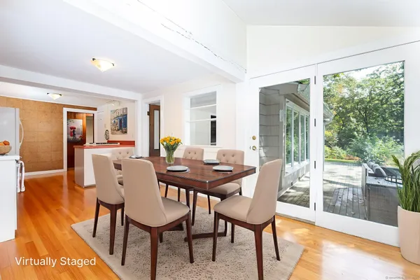 a view of a dining room with furniture and wooden floor