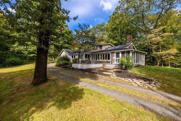 a view of a house with swimming pool and sitting area