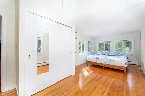 a bedroom with a bed and wooden floor