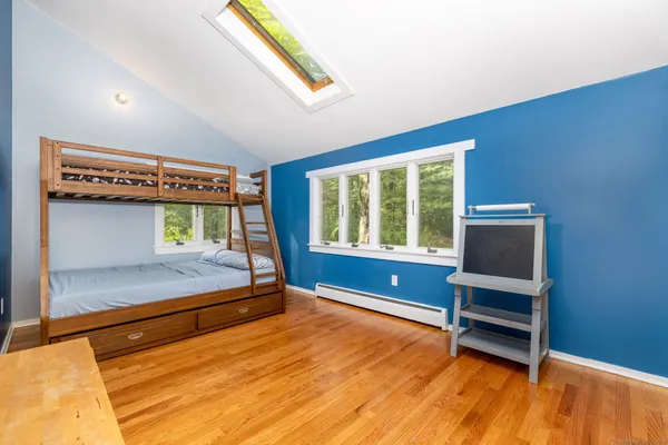 a bedroom with a bed and a window