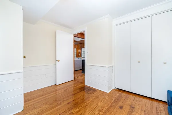 a view of empty room with wooden floor