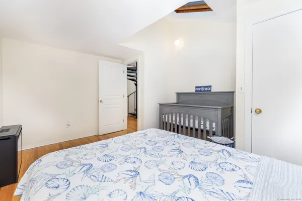 a bedroom with a bed and a lamp
