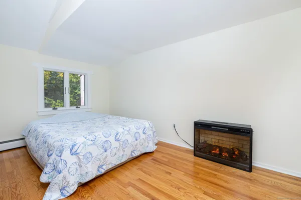 a bedroom with a bed and a wooden floor