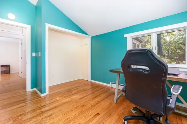 a view of a livingroom with wooden floor and a window