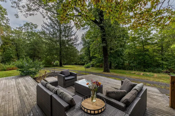 a view of a patio with couches chairs and a yard