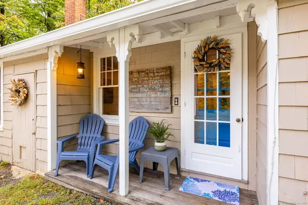 a view of a porch with a table and chairs and potted plants