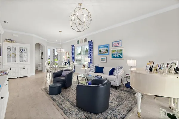 a living room with furniture large window and flat screen tv