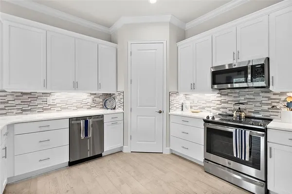 a kitchen with granite countertop a sink and cabinets