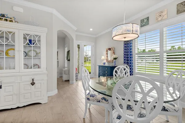 a view of a dining room with furniture and chandelier