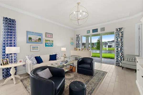 a living room with furniture and a floor to ceiling window