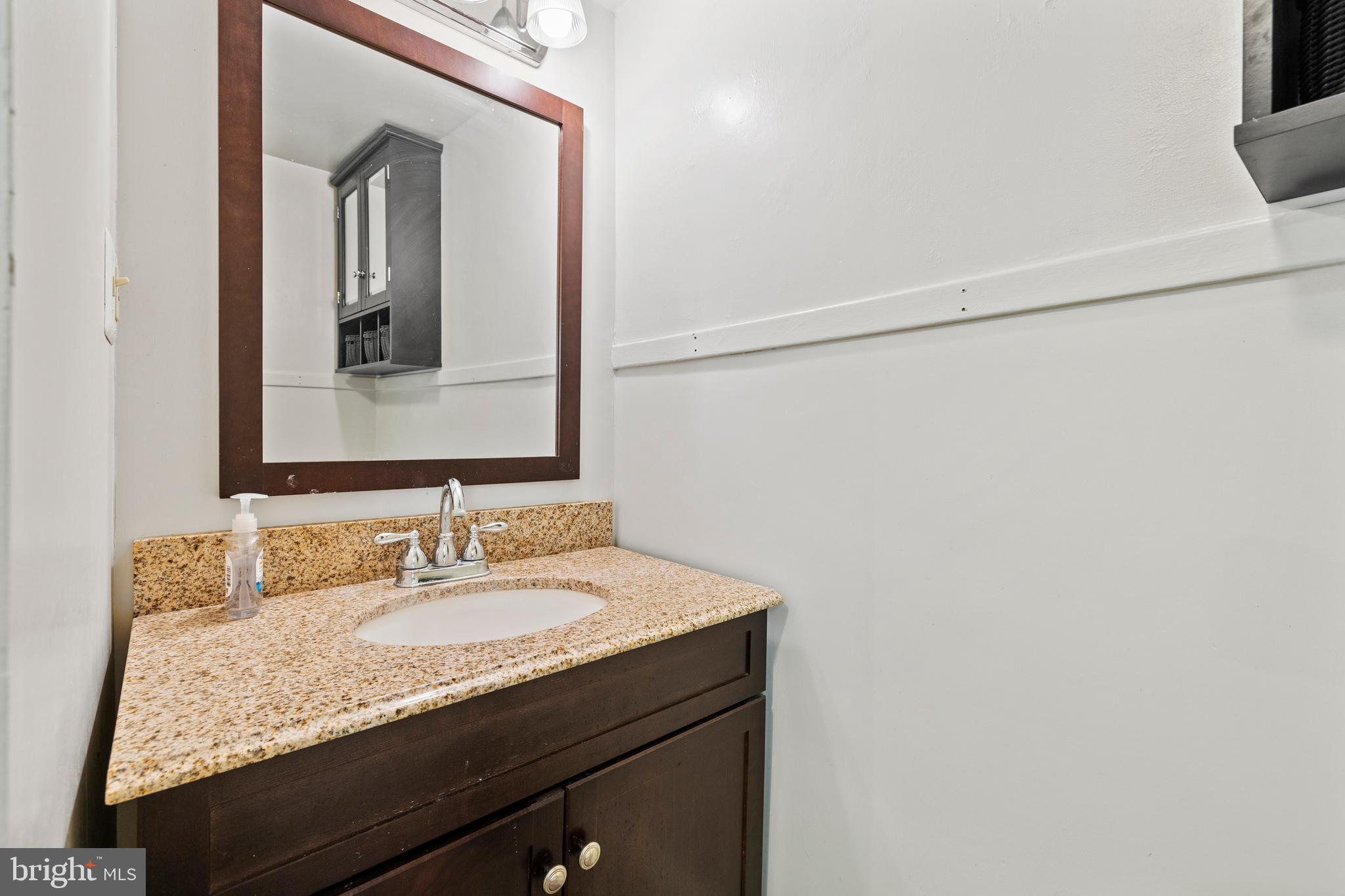 14111 Green Road Glyndon, MD 21136 - Photo 109 of 146 a bathroom with a granite countertop sink and a mirror