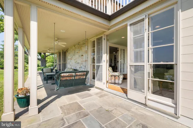 a front view of a house with a yard table and chairs