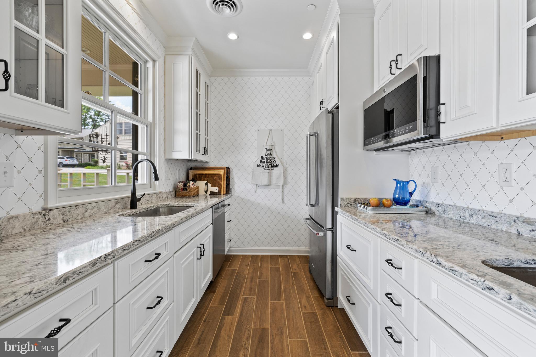 14111 Green Road Glyndon, MD 21136 - Photo 95 of 146 a kitchen with granite countertop stainless steel appliances a sink stove top oven and microwave