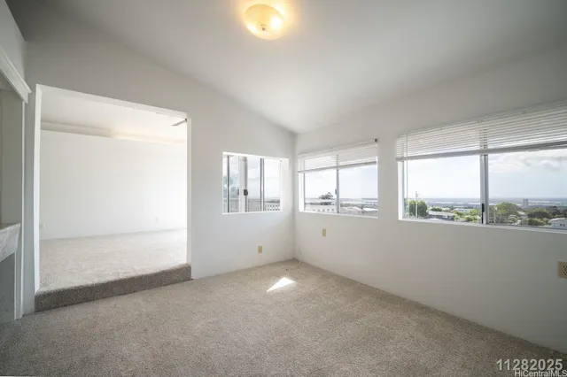 a view of empty room with windows and city view