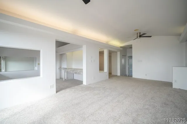 an empty room with a cabinet and a window