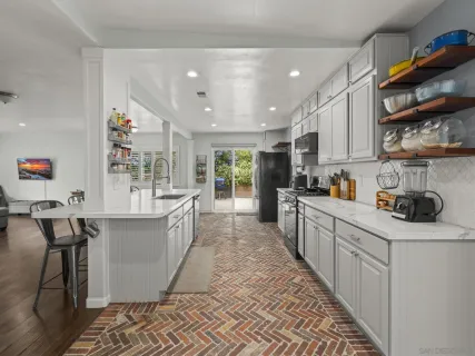 a kitchen with stainless steel appliances granite countertop a sink and cabinets