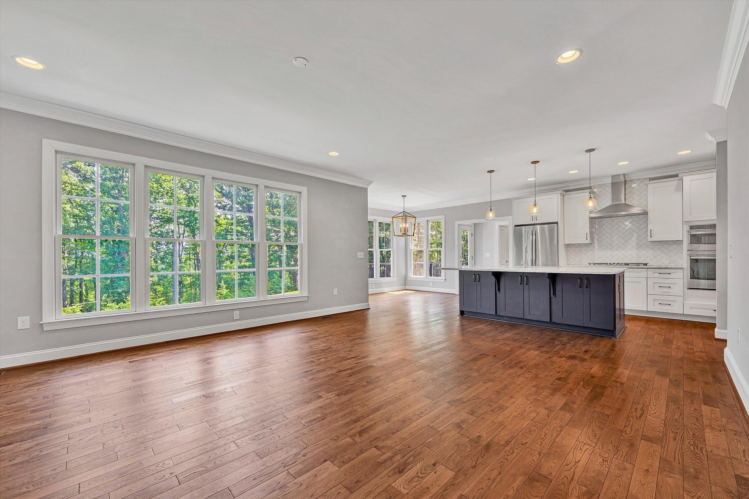 6981 Fairway Ridge Road Salem, VA 24153 - Photo 14 of 53 a view of empty room with wooden floor and kitchen view