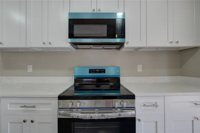 a stove top oven sitting inside of a kitchen