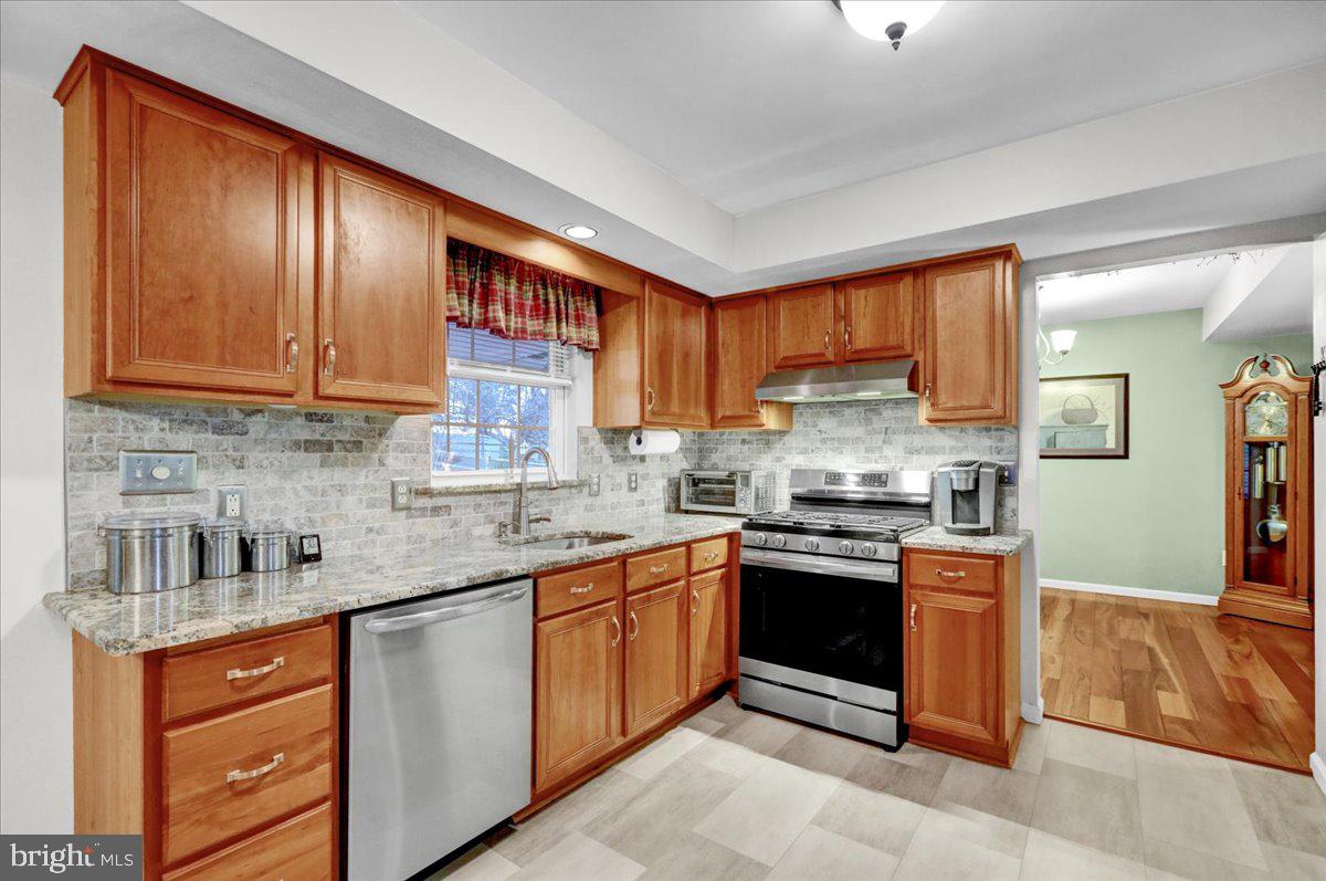 9 Roxberry Drive Reading, PA 19608 - Photo 11 of 40 a kitchen with stainless steel appliances granite countertop wooden cabinets a stove top oven a sink and dishwasher