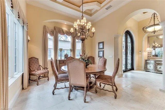 a view of a dining room with furniture and a chandelier