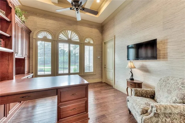 a living room with furniture a chandelier and a floor to ceiling window