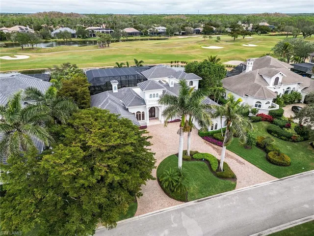 an aerial view of a house with outdoor space and lake view