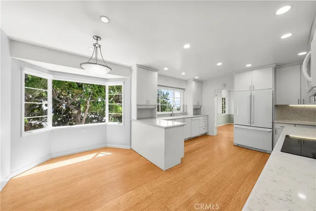 a view of a small space with wooden floor and a window