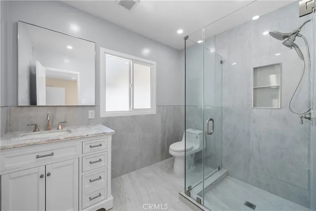 a view of a house with a small yard and potted plants