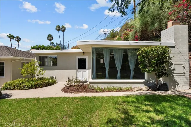 a view of an empty room with a fireplace and a window