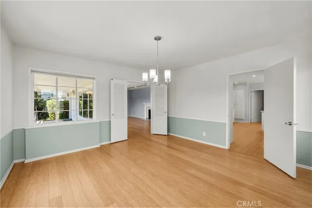 a large white kitchen with cabinets