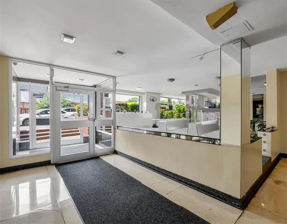 1075 Sheepshead Bay Road, Unit 2J Brooklyn, NY 11229 - Photo 2 of 9 a kitchen with appliances cabinets and a table
